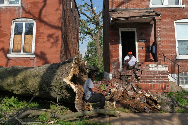 People survey damage after a severe storm moved through Friday, May 16, 2025, in St. Louis. 