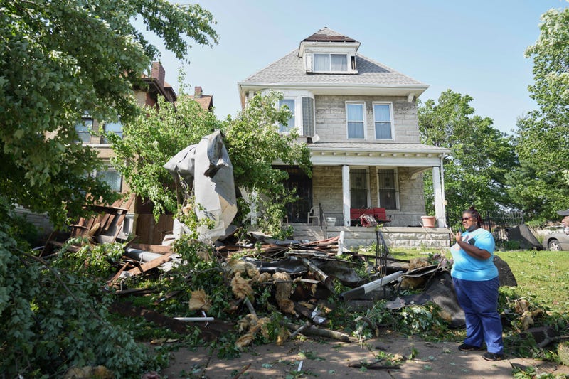 People survey damage after a severe storm moved through Friday, May 16, 2025, in St. Louis.