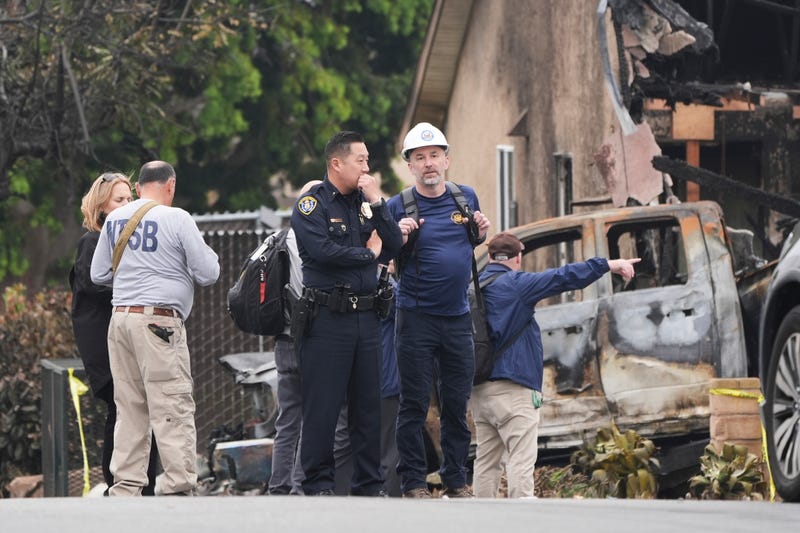 Investigators work at the site of a plane crash Friday, May 23, 2025, in San Diego.