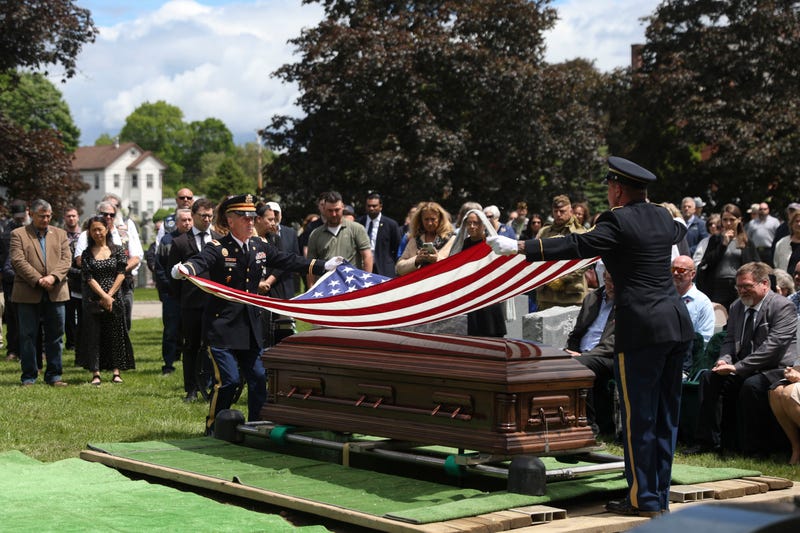 An American flag is folded during the interment for World War II U.S. Army Air Forces Staff Sgt. Eugene Darrigan at the cemetery behind St. Mary's church, Saturday, May 24, 2025, in Wappingers Falls, N.Y. Darrigan was buried in his hometown after his remains were recovered from a World War II bomber that crashed into the water off the coast of New Guinea on March 11, 1944.
