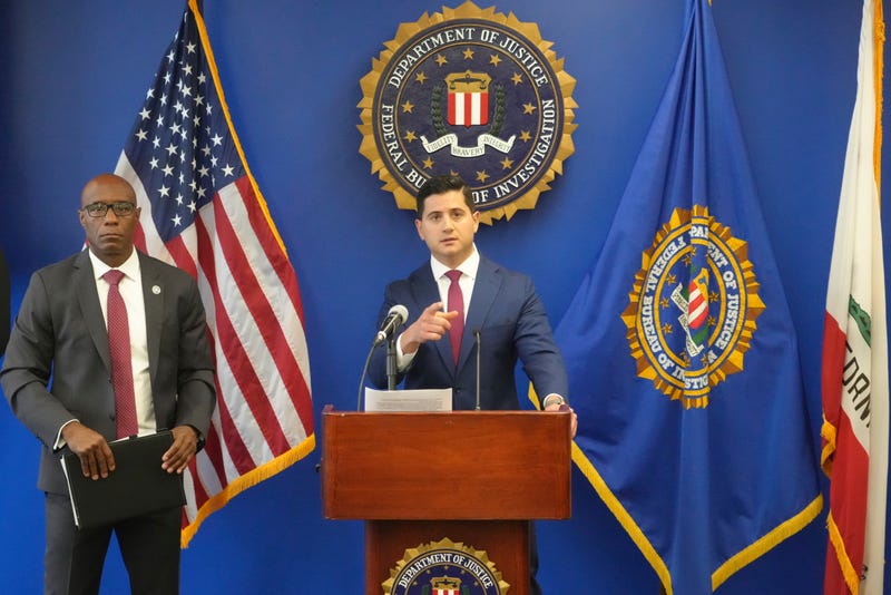 U.S. Attorney Bill Essayli, at podium, with Akil Davis, Assistant Director in Charge of the FBI's Los Angeles Field Office, left, answer questions about the arrest of a Washington state man accused of providing chemicals used in last month's bombing in Palm Springs, Calif., during a news conference in Los Angeles Wednesday, June 4, 2025. 