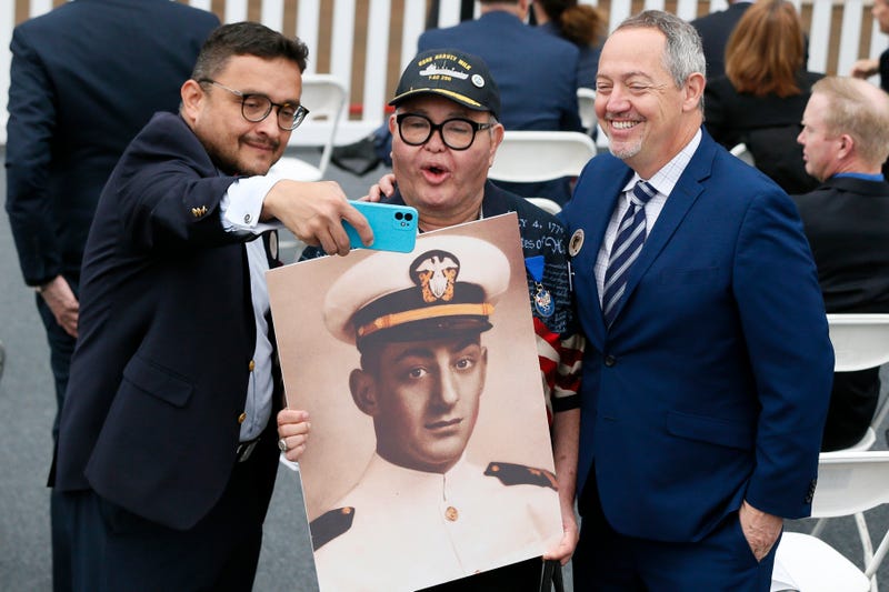 FILE - David Campos, left, vice chair of the California Democratic Party, takes a selfie with Nicole Murray-Ramirez, center, an LGBT activist, holding a photo of Harvey Milk, and Bevan Dufty, right, director of the San Francisco Bay area rapid transit district, prior to the launching of the USNS Harvey Milk