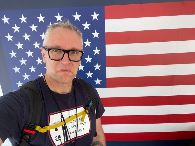 In this photo provided by Joe Plenzler, U.S. Marine Corps veteran Joe Plenzler poses in Washington, June 6, 2025, during the Unite For Veterans Coalition protest, which he helped organize.