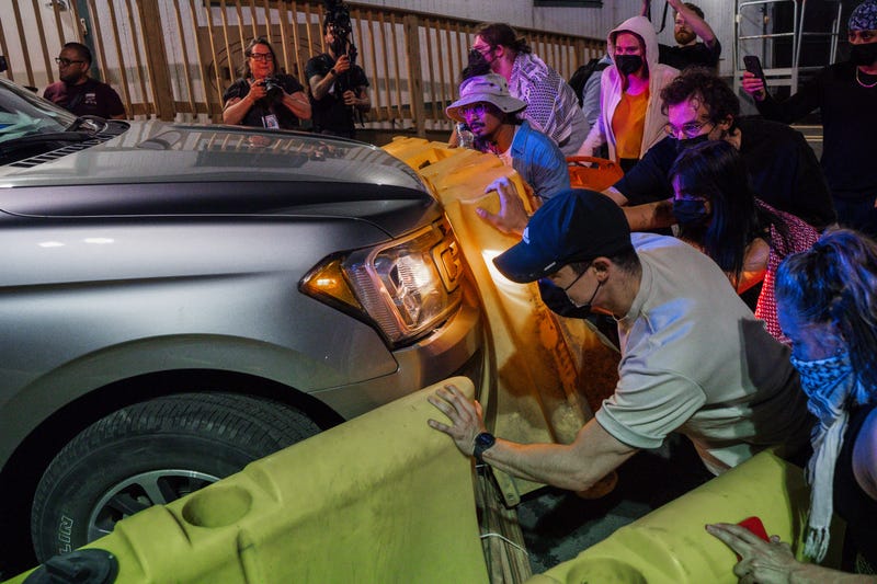 Protesters attempt to block a vehicle from leaving the Delaney Hall Detention Facility during protests over federal immigration enforcement raids on Thursday, June 12, 2025, in Newark