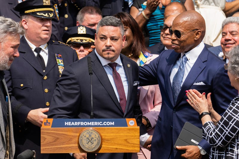 Edward A. Caban, center, speaks after being sworn in as NYPD police commissioner outside New York City Police Department 40th Precinct on July 17, 2023, in New York. Mayor Eric Adams on the right. 