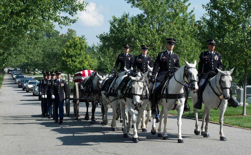 FILE - A U.S. Army Caisson team carries the casket of Army Capt. Stephanie Rader, during a full military honors conducted by the Army's 3rd U.S. Infantry Regiment through Arlington National Cemetery in Arlington, Va., June 1, 2016.