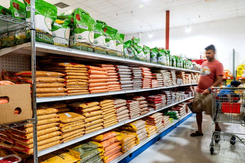 A customer shops a grain aisle at New India Bazar, where most merchandise is imported from India and Canada, Aug. 6, 2025, in Fremont, California. 