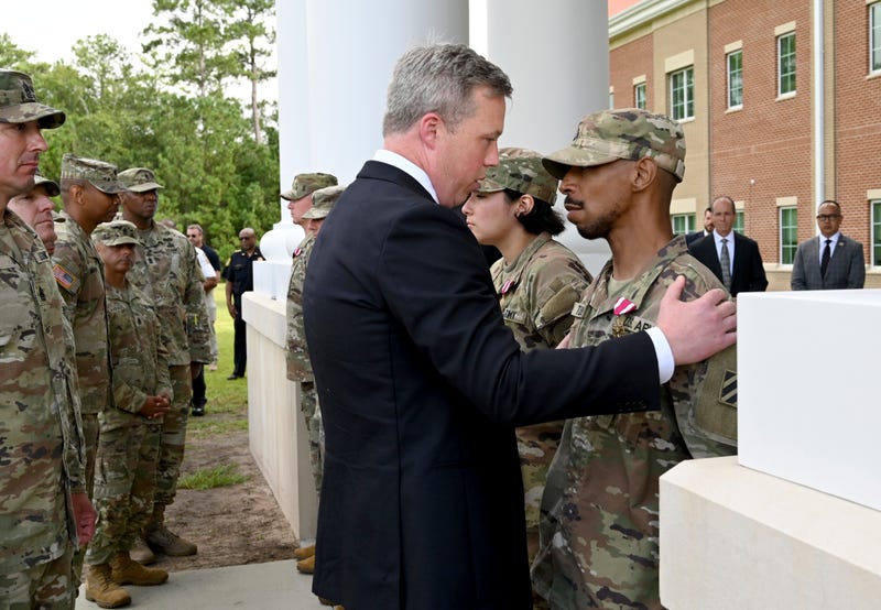 Army Secretary Dan Driscoll congratulates Sergeant Aaron Turner after Turner received the Meritorious Service Medal with five other soldiers outside Fort Stewart in Georgia, Thursday, Aug. 6, 2025.