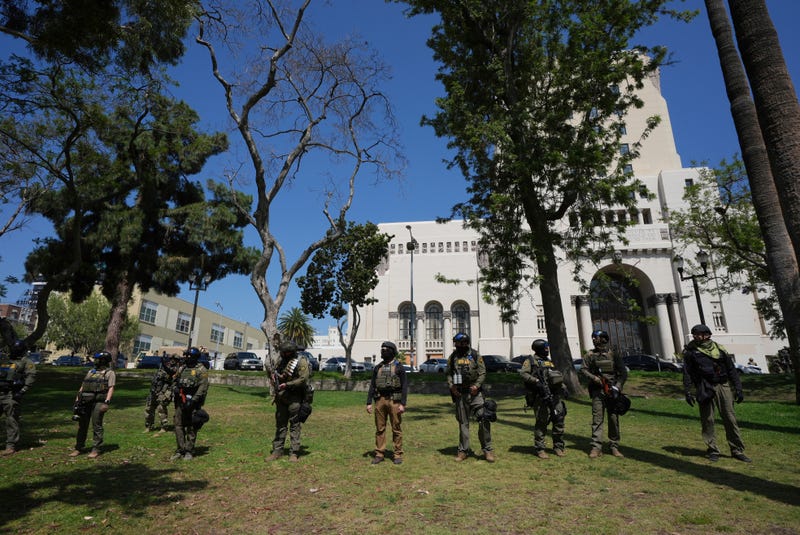 FILE - Federal agents stage at MacArthur Park, July 7, 2025, in Los Angeles.