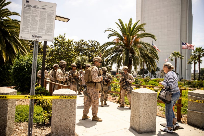 FILE - Members of the California National Guard and U.S. Marines, guard the entrance outside the Wilshire Federal in Los Angeles, June 13, 2025.