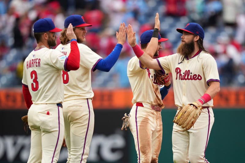 Philadelphia Phillies' Bryce Harper, from left, Alec Bohm, Trea Turner and Brandon Marsh celebrate after the Phillies won a baseball game against the Seattle Mariners Wednesday, Aug. 20, 2025, in Philadelphia.