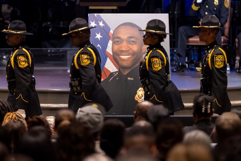 Law enforcement officers march during the funeral of DeKalb County Police Officer David Rose, who was killed while responding to a shooting at the CDC, at First Baptist Church Atlanta, Friday, Aug. 22, 2025, in Atlanta.