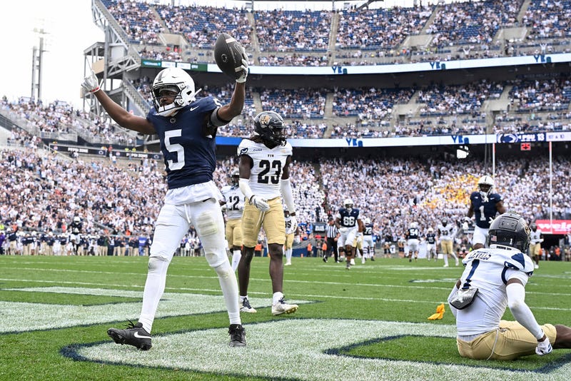 Penn State wide receiver Devonte Ross (5) celebrates a touchdown in front of Florida International defenders Ashton Levells (1) and Jessiah McGrew (23) during the third quarter of an NCAA college football game, Saturday, Sept. 6, 2025, in State College, Pa.