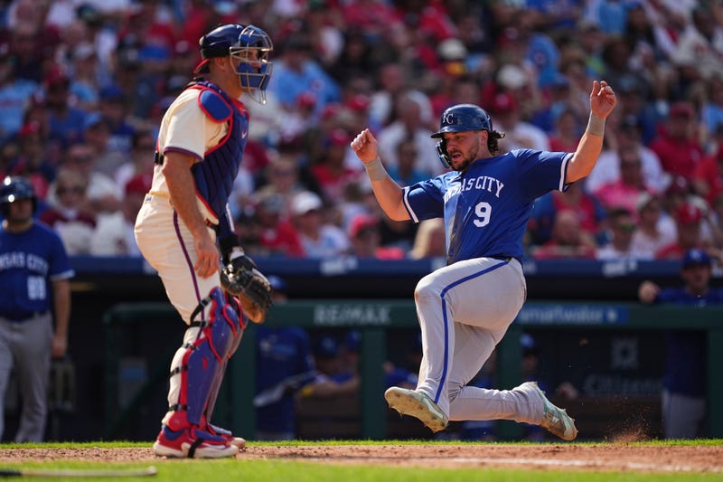 Kansas City Royals' Vinnie Pasquantino (9) scores past Philadelphia Phillies catcher J.T. Realmuto, left, off an RBI single by teammate Salvador Perez during the seventh inning of a baseball game, Sunday, Sept. 14, 2025, in Philadelphia.