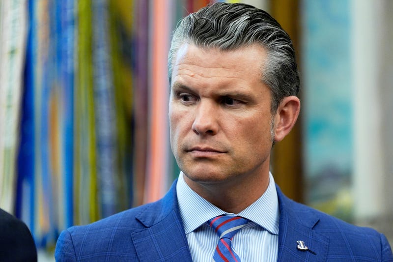 Defense Secretary Pete Hegseth listens as President Donald Trump speaks in the Oval Office of the White House, Monday, Sept. 15, 2025, in Washington.