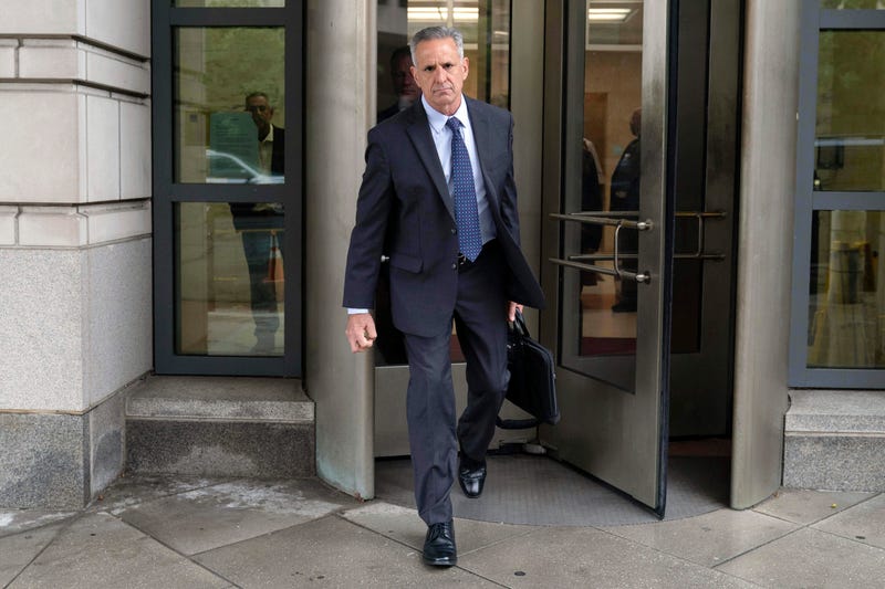 Retired Adm. Robert P. Burke, 63, walks out of the federal courthouse after being sentenced to six year in prison for his conviction on corruption charges, Tuesday, Sept. 16, 2025, in Washington.