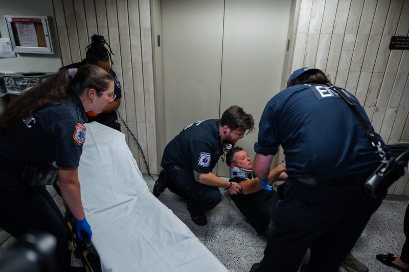 Medics transfer journalist L. Vural Elibol to a gurney after he was shoved by federal agents in immigration court on Tuesday, Sept. 30, 2025, in New York