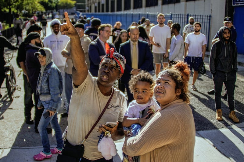 People take a look at part of a building that collapsed in the Bronx borough of New York, Wednesday, Oct. 1, 2025