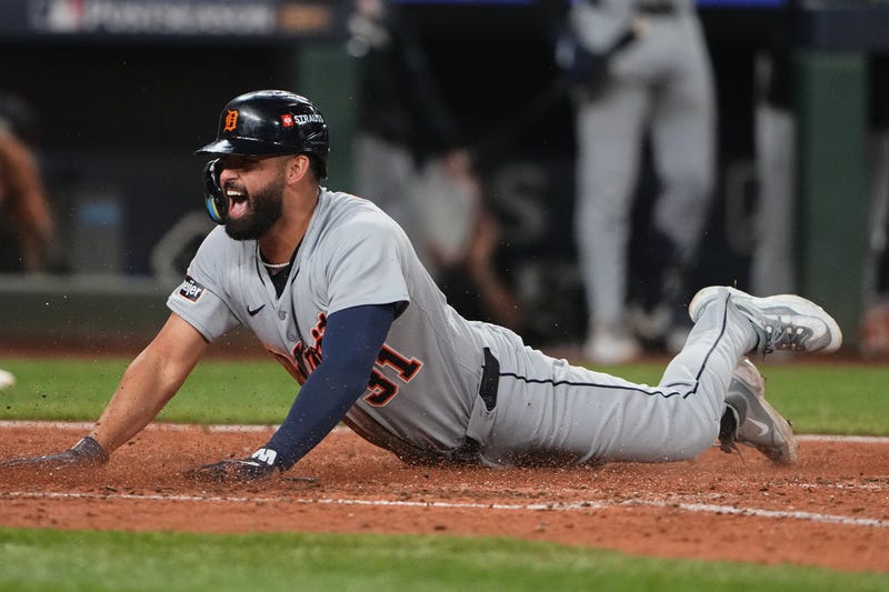 Detroit Tigers' Riley Greene reacts after sliding home to score the tying run