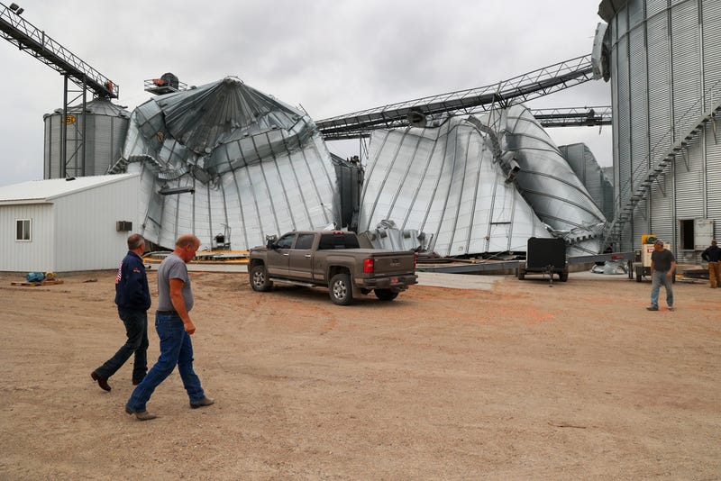 North Dakota Governor Kelly Armstrong walks by silos damaged by an EF5 tornado in Enderlin, N.D., on June 25, 2025. 