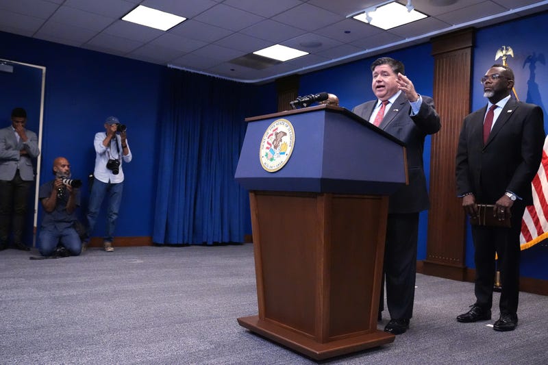Governor JB Pritzker, second from right, speaks as Chicago Mayor Brandon Johnson, right, listens to him at a news conference in Chicago, Monday, Oct. 6, 2025.