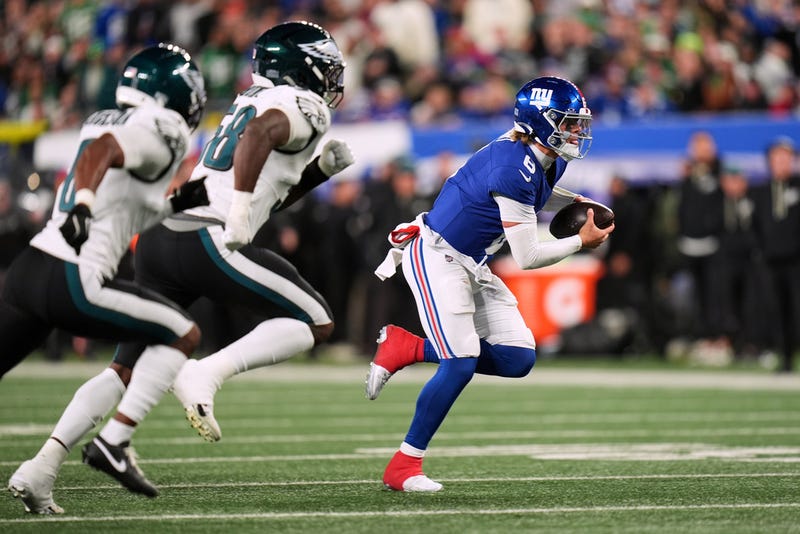 New York Giants' Jaxson Dart runs during the first half of an NFL football game against the Philadelphia Eagles Thursday, Oct. 9, 2025, in East Rutherford, N.J.