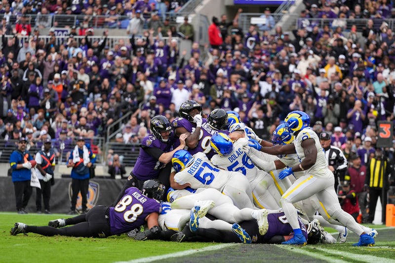 Baltimore Ravens tight end Mark Andrews, center left, and teammates attempt a tush push play against the Los Angeles Rams during the first half of an NFL football game Sunday, Oct. 12, 2025, in Baltimore. 
