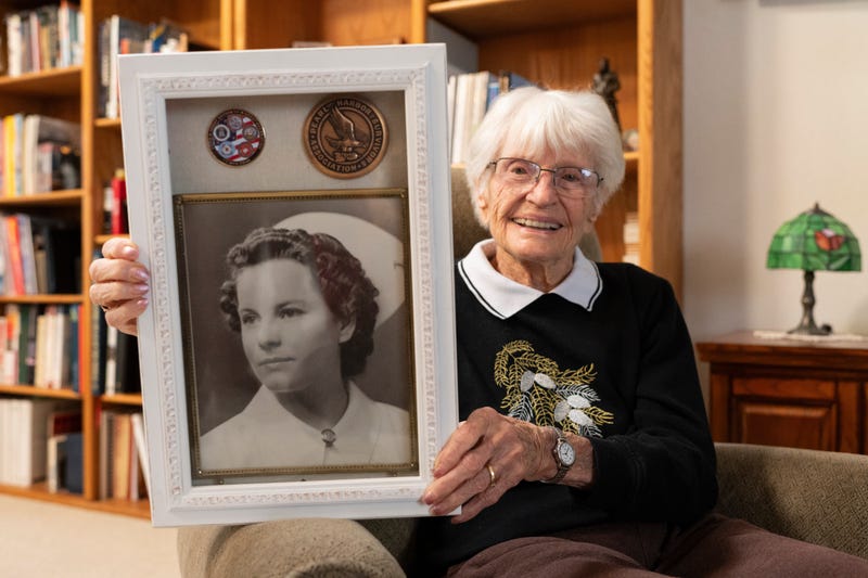 Alice Darrow shows a photo of herself from when she was a nurse during World War II, Thursday, Oct. 23, 2025, at her home in Danville, Calif.