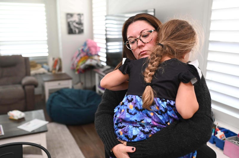 Jennifer Bittner holds her 6-year-old daughter Amelia at their home on Wednesday, Oct. 29, 2025, in Pflugerville, Texas.