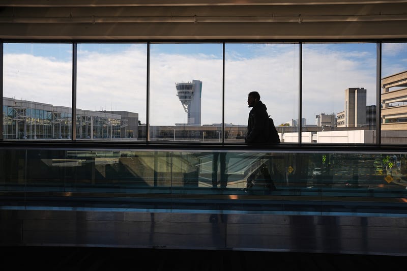 A traveler moves in view of a control tower at Philadelphia International Airport in Philadelphia, Nov. 5, 2025. 
