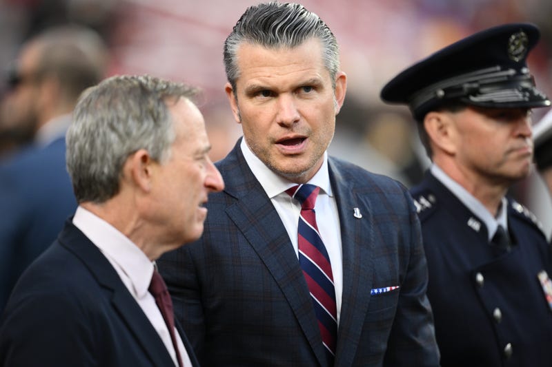 Defense Secretary Pete Hegseth is seen on the sidelines before an NFL football game between the Washington Commanders and the Detroit Lions Sunday, Nov. 9, 2025, in Landover, Md.