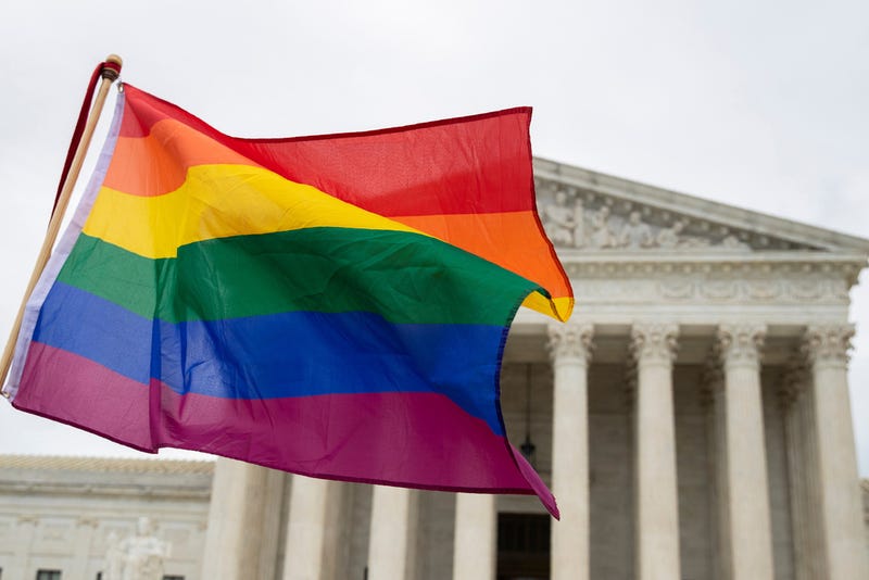 Supporters of the LGBT wave their flag in front of the U.S. Supreme Cour, Oct. 8, 2019, in Washington. 