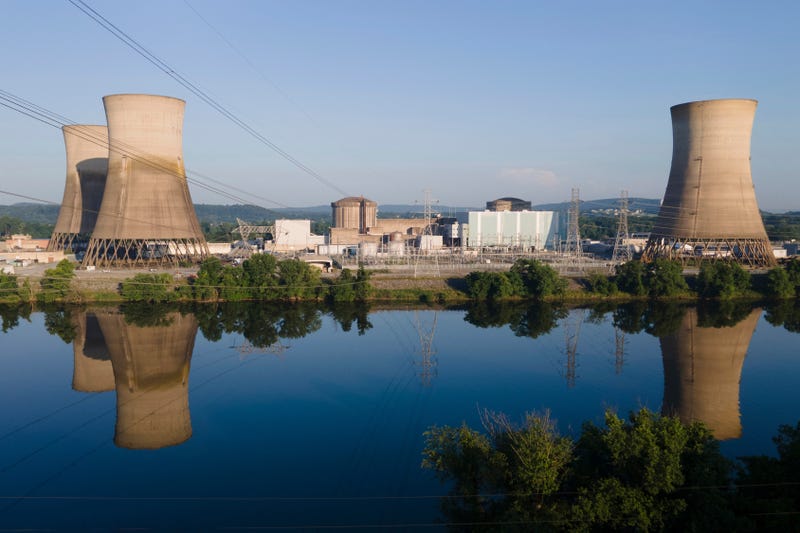At Constellation's nuclear power plant on Three Mile Island, called the Crane Clean Energy Center, near Middletown, Pa., the cooling towers are reflected in the Susquehanna River at sunrise, June 25, 2025. 