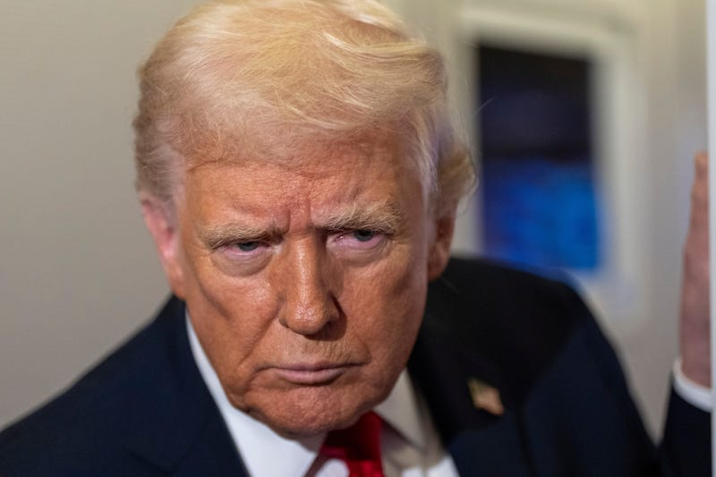 President Donald Trump leans in to hear a question as he speaks with reporters while in flight on Air Force One from Joint Base Andrews to his Mar-a-Lago estate in Palm Beach, Fla., Tuesday, Nov. 25, 2025.