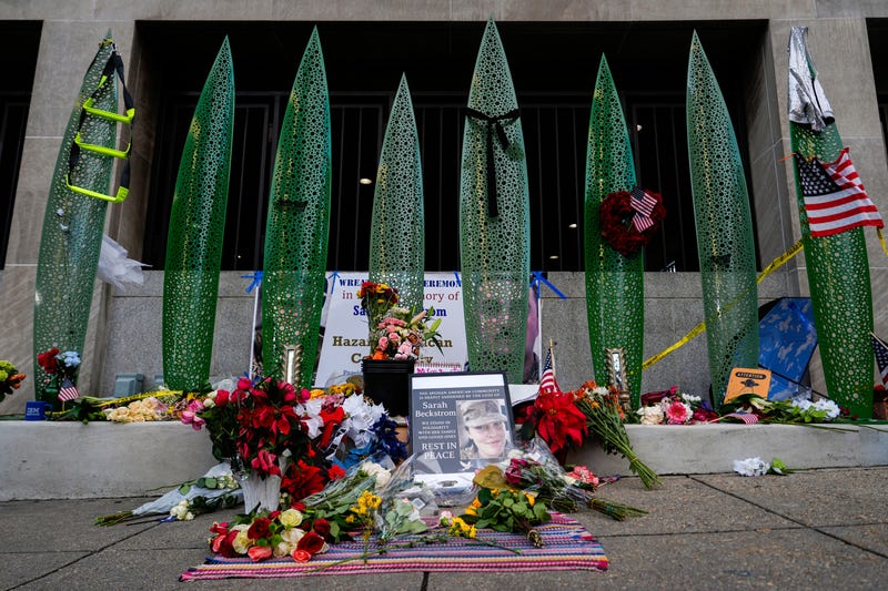 A makeshift memorial for U.S. Army Spc. Sarah Beckstrom and U.S. Air Force Staff Sgt. Andrew Wolfe is seen outside of Farragut West Station, near the site where the two National Guard members were shot, Monday, Dec. 1, 2025, in Washington.