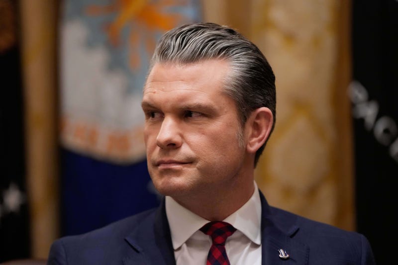 Defense Secretary Pete Hegseth listens as President Donald Trump speaks during a Cabinet meeting at the White House, Tuesday, Dec. 2, 2025, in Washington.