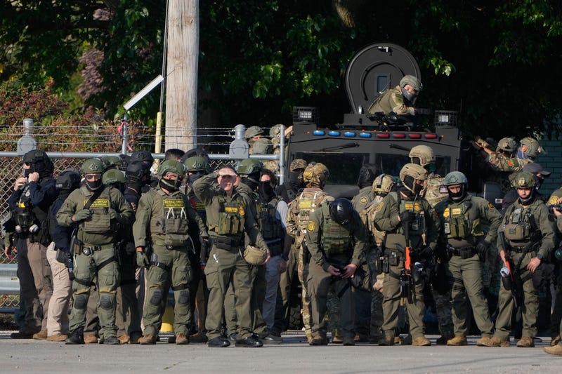 FILE - Greg Bovino, the chief patrol agent for the U.S. Border Patrol El Centro sector, center, stands with federal immigration agents near an Immigration and Customs Enforcement facility in Broadview, Ill., Oct. 3, 2025.