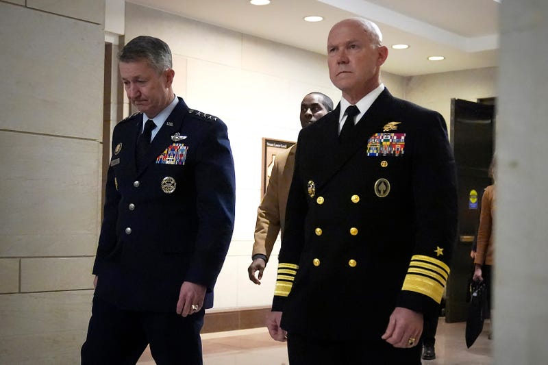 U.S. Navy Adm. Frank M. Bradley, right, accompanied by Gen. Dan Caine, chairman of the Joint Chiefs of Staff, left, walks to a meeting with senators on Capitol Hill, Thursday, Dec. 4, 2025, in Washington.