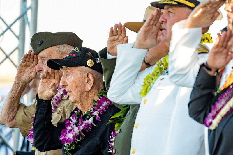 World War II veterans and government officials salute during the 84th Pearl Harbor Remembrance Day Ceremony, Sunday, Dec. 7, 2025, in Honolulu. 