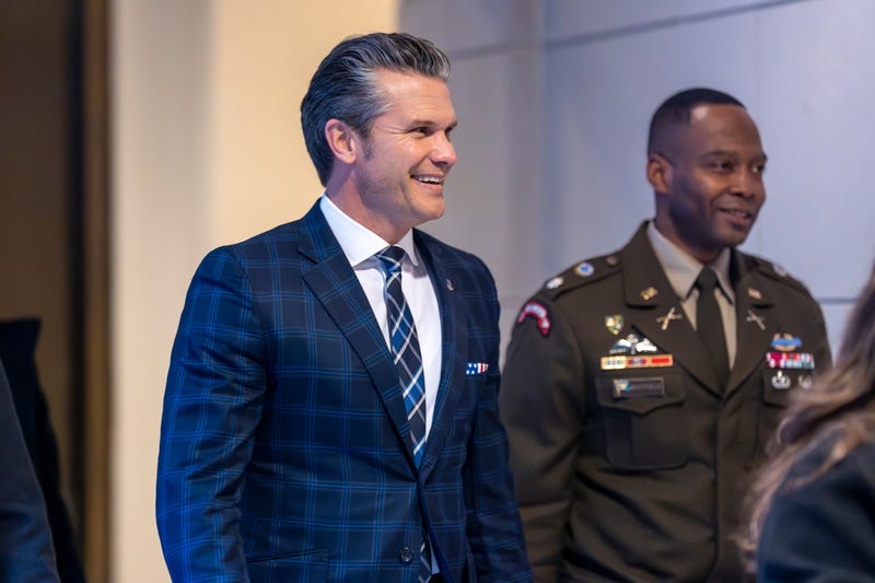 Defense Secretary Pete Hegseth smiles as he walks to a secure room in the basement of the Capitol to brief lawmakers on how he handled a military strike on a suspected drug smuggling boat and its crew in the Caribbean near Venezuela Sept. 2, at the Capitol in Washington, Tuesday, Dec. 9, 2025.