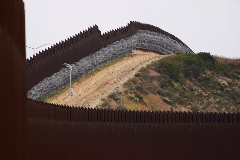 Concertina wire lines the interior of a border wall separating Tijuana, Mexico, from the United States, June 4, 2025, in San Diego.