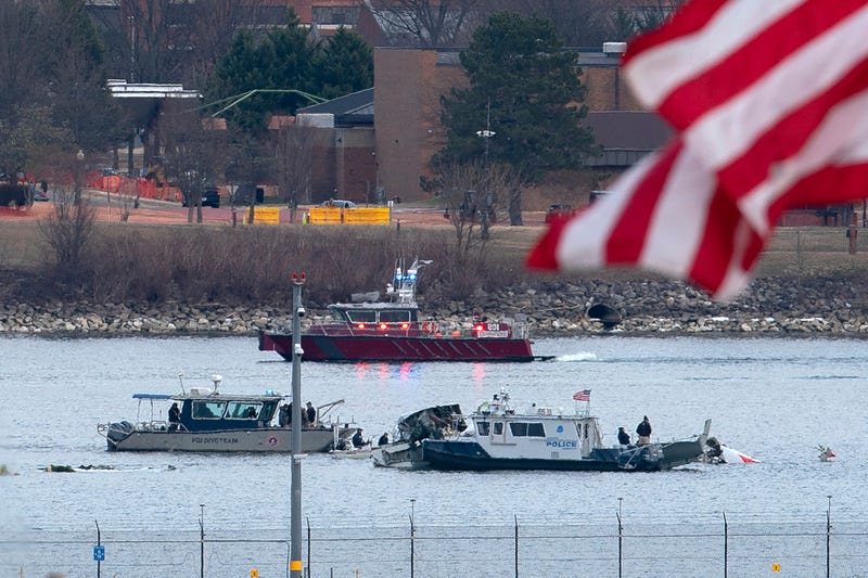 FILE - A diving team and police boat is seen near a wreckage site in the Potomac River, from Ronald Reagan Washington National Airport, Jan. 30, 2025, in Arlington, Va.