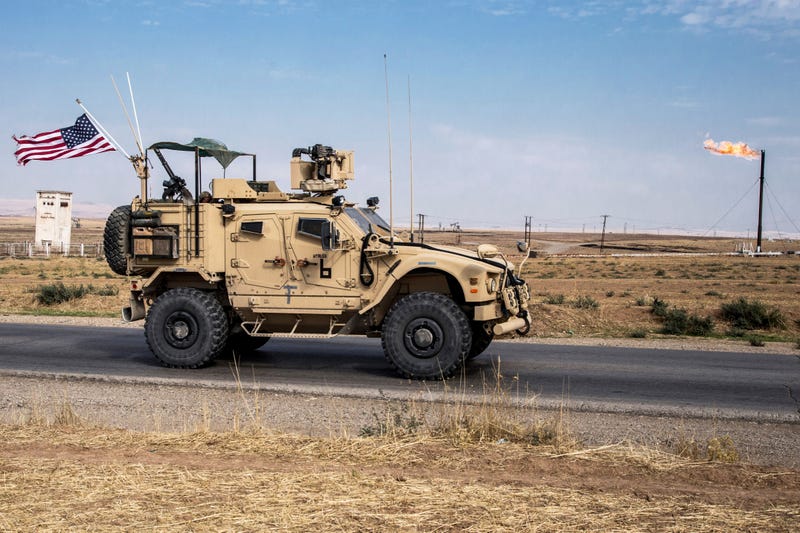 FILE - U.S. forces patrol oil fields in Syria, Oct. 28, 2019.
