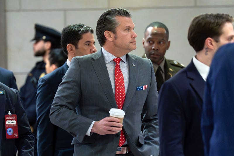 Defense Secretary Pete Hegseth walks to the auditorium to brief members of Congress on military strikes near Venezuela at the Capitol, Tuesday, Dec. 16, 2025, in Washington.