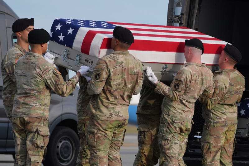 An Army carry team places the flag-draped transfer case with the remains of civilian interpreter Ayad Mansoor Sakat of Macomb, Mich., into the transfer vehicle during a casualty return, Wednesday, Dec. 17, 2025, at Dover Air Force Base, Del.