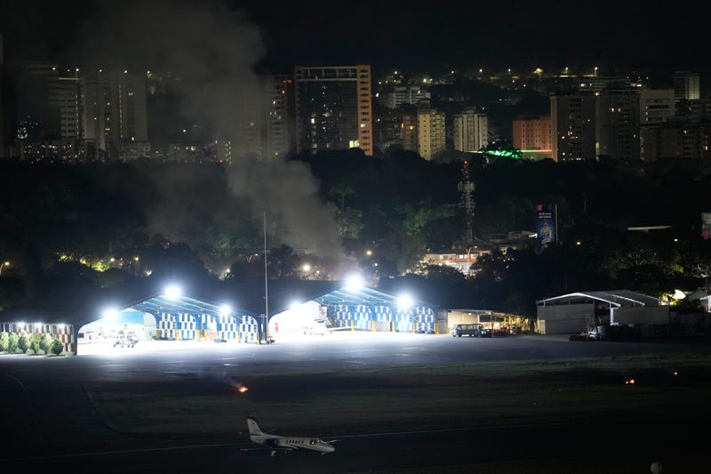 Smoke raises at La Carlota airport after explosions and low-flying aircraft were heard in Caracas, Venezuela, Saturday, Jan. 3, 2026.