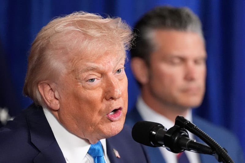 President Donald Trump speaks at his Mar-a-Lago club, Saturday, Jan. 3, 2026, in Palm Beach, Fla., as Defense Secretary Pete Hegseth listens.