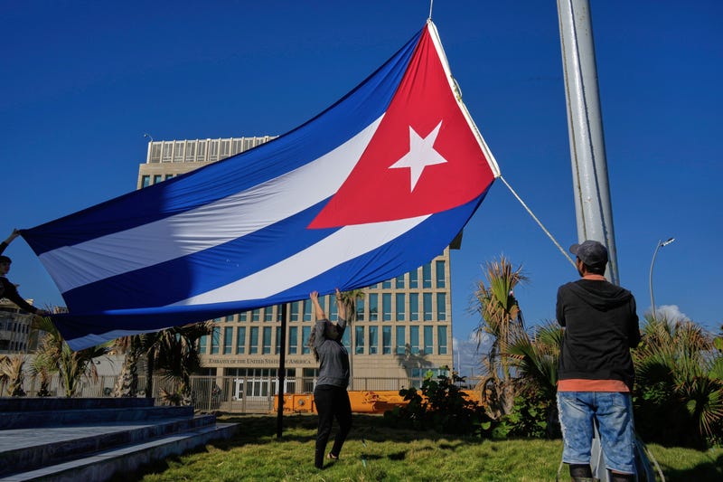 Workers fly the Cuban flag at half-mast at the Anti-Imperialist Tribune near the U.S. embassy in Havana, Cuba, Monday, Jan. 5, 2026, in memory of Cubans who died two days before in Caracas, Venezuela during the capture of Venezuelan President Nicolas Maduro by U.S. forces.