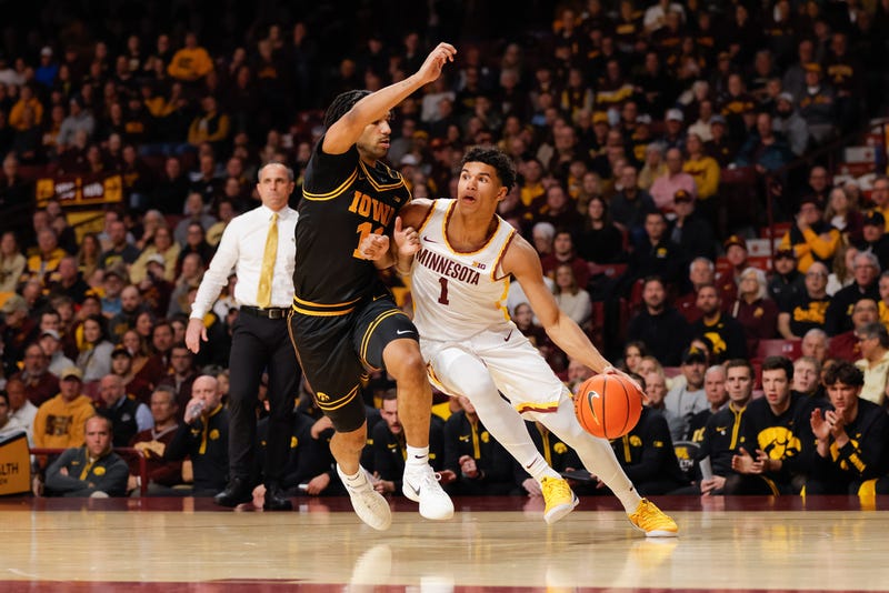Minnesota Golden Gophers guard Isaac Asuma (1) drives to the basket while Iowa Hawkeyes guard Kael Combs defends during the first half of an NCAA college basketball game Tuesday, Jan. 6, 2026, in Minneapolis. 
