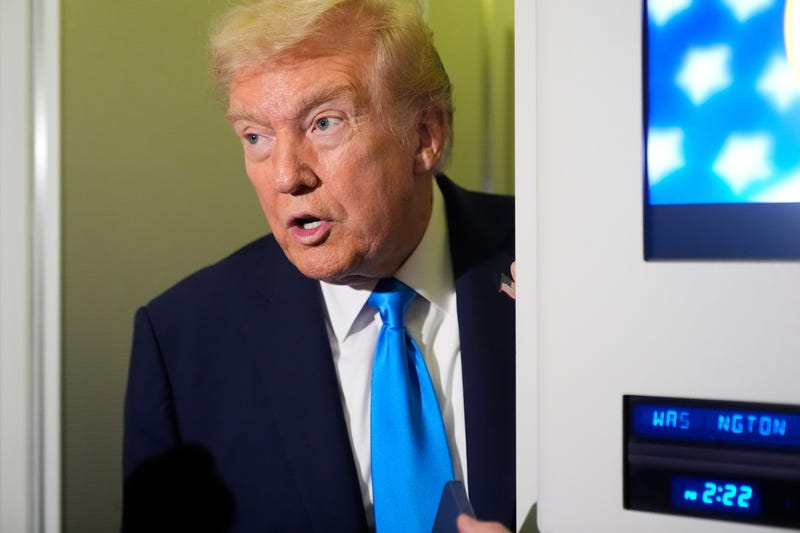 FILE - President Donald Trump speaks with reporters aboard Air Force One at Al Udeid Air Base in Doha, Qatar, Oct. 25, 2025. 